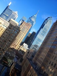 Low angle view of buildings against blue sky