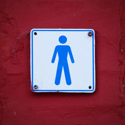 Male toiletsign on old wall