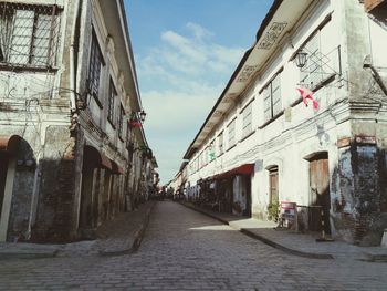 Street amidst buildings against sky