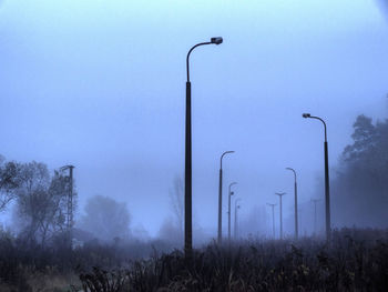 Street light on field against sky