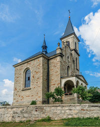 Cloudy landscape with stone church. catholic church on background of cloudy sky.