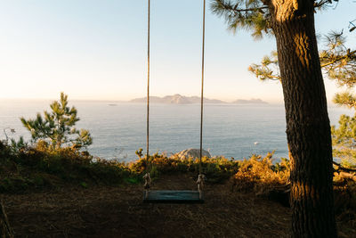 View of the monteferro swing at sunset with the cies islands in the background. nigran - galicia