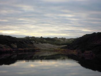 Scenic view of lake against sky during sunset