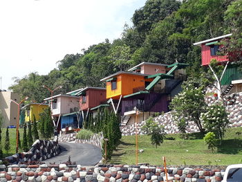 Buildings by street in city against sky