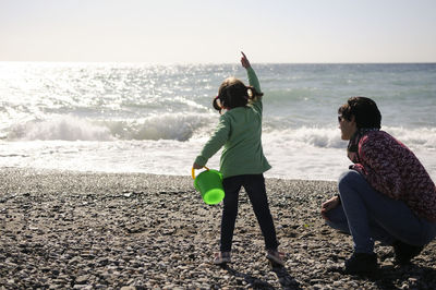 Mother and daughter playing at beach