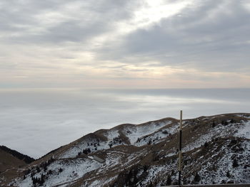 Scenic view of snow covered land against sky during sunset