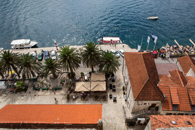 Roofs of old houses in perast and bay with mountains in montenegro