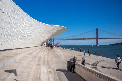 View of suspension bridge against clear blue sky