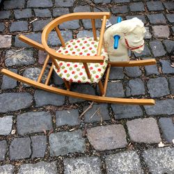 High angle view of rocking horse on cobblestone street