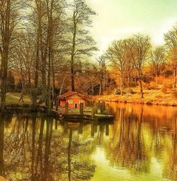 Scenic view of lake against sky at sunset