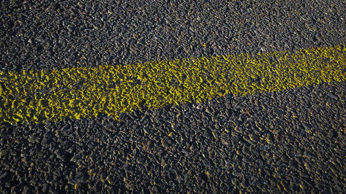 High angle view of yellow road marking on street