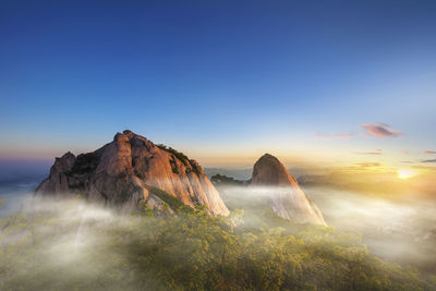 Scenic view of mountain peak against sky during sunset