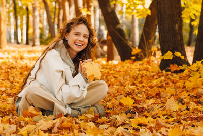 Portrait of young woman looking away in park