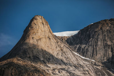 Alpenglow on rocky granite spire on baffin island.