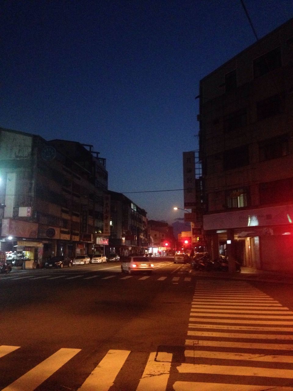 building exterior, illuminated, architecture, built structure, night, city, street, street light, transportation, city street, road, city life, car, building, sky, the way forward, outdoors, dusk, clear sky, residential structure