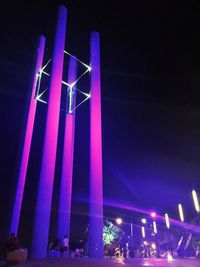 Low angle view of illuminated lights against blue sky