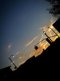 Low angle view of silhouette street against sky during sunset