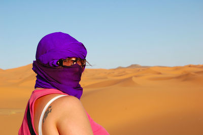 Rear view of woman wearing hat against clear sky