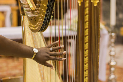 Close-up of hand playing piano