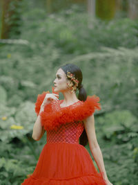 Side view of young woman standing on field