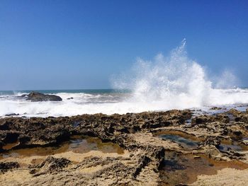 Waves splashing on rocks at beach