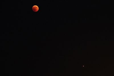 Low angle view of moon against sky at night