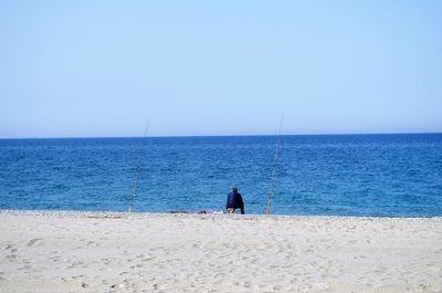 Scenic view of sea against clear blue sky