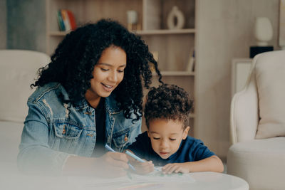 Mother and girl looking at camera