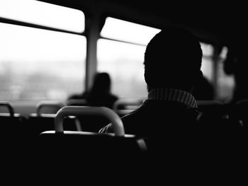 Rear view of man sitting in bus