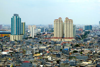 High angle view of buildings in city against sky