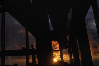 Silhouette bridge against sky at night