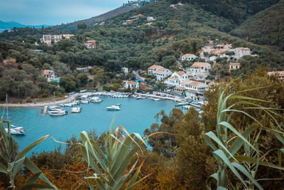 High angle view of houses by sea against sky