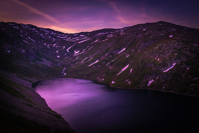 High angle view of river amidst mountains against sky at night