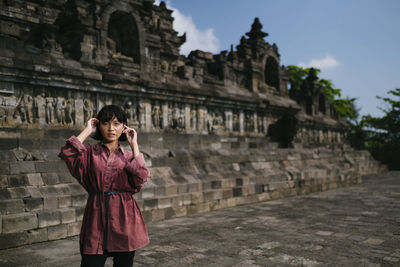 Full length of man standing outside temple