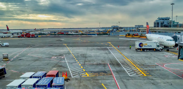 High angle view of airplane on airport runway against sky