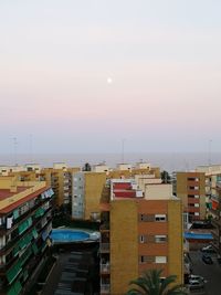 High angle view of buildings against sky during sunset