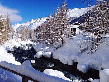 High angle view of river amidst snow covered field