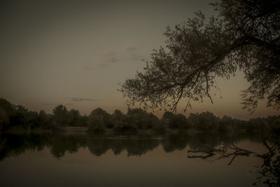 Scenic view of lake against sky at sunset