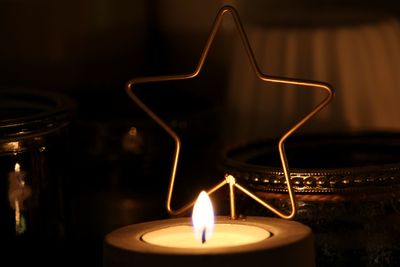 Close-up of illuminated candles on table