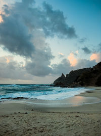 Scenic view of beach against sky during sunset