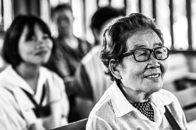 Smiling senior woman wearing eyeglasses looking away