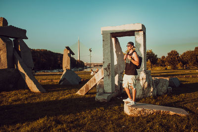 Man standing on field against sky