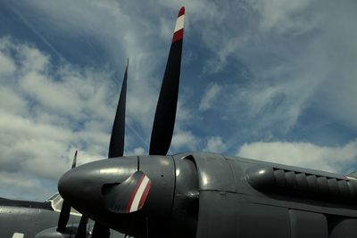 Low angle view of airplane flying against sky