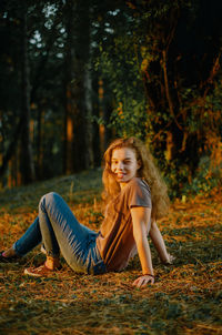 A young woman sitting on grass and smiling