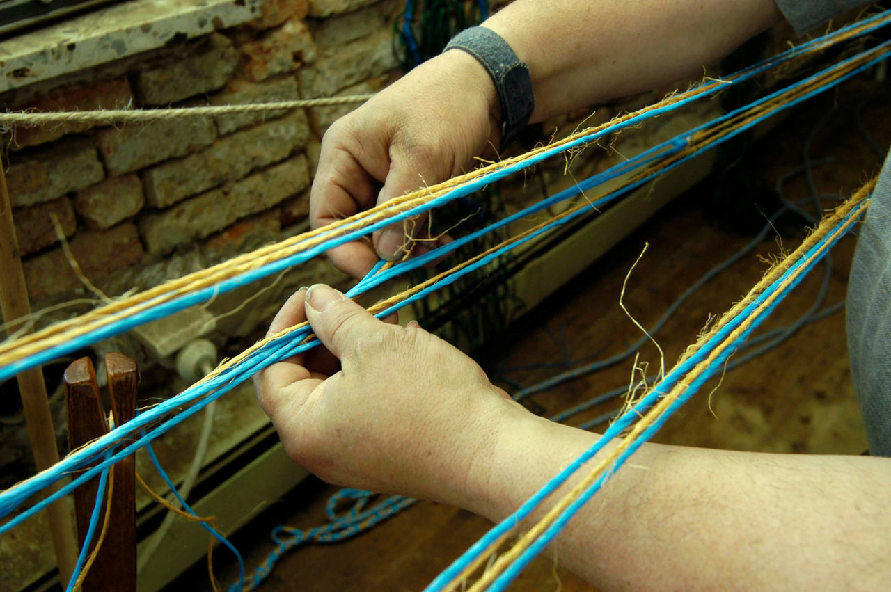 CLOSE-UP OF PERSON WORKING IN THE WALL