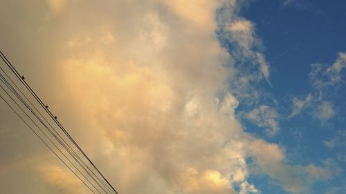 Low angle view of cables against sky