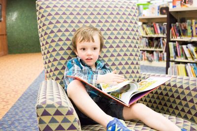 Portrait of boy reading book