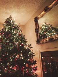 Low angle view of illuminated christmas tree at night