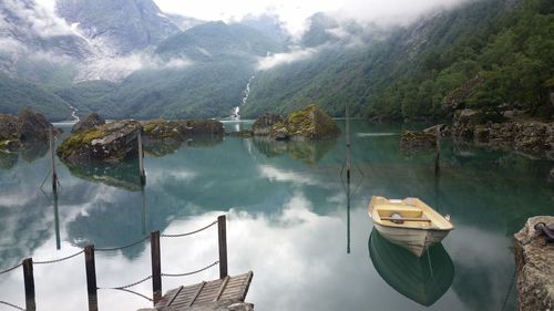 Panoramic view of boats moored in lake against mountains