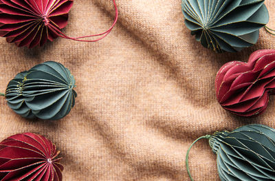 Handmade eco paper ball, closeup view. christmas holiday decorations on a brown knitted background.